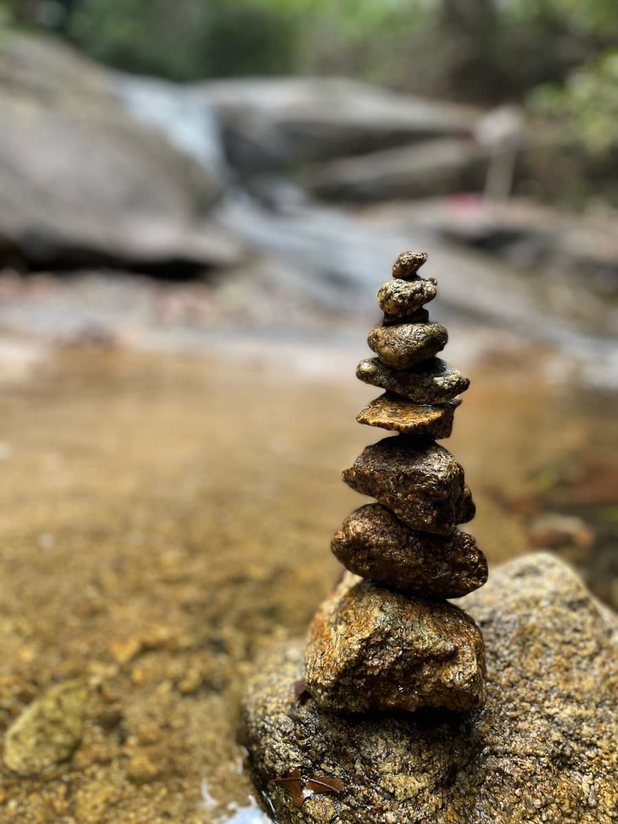A cairn of pebbles stacked on a rock at Ton Chong Fa waterfall, Thailand